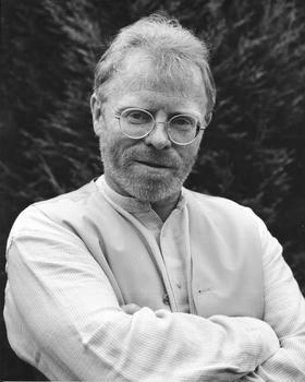 Frank Ormsby standing with his arms crossed