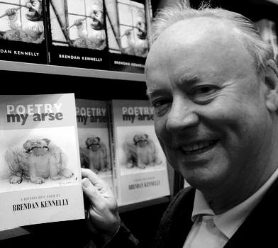 Brendan Kennelly in front of shelves with copies of his books on them